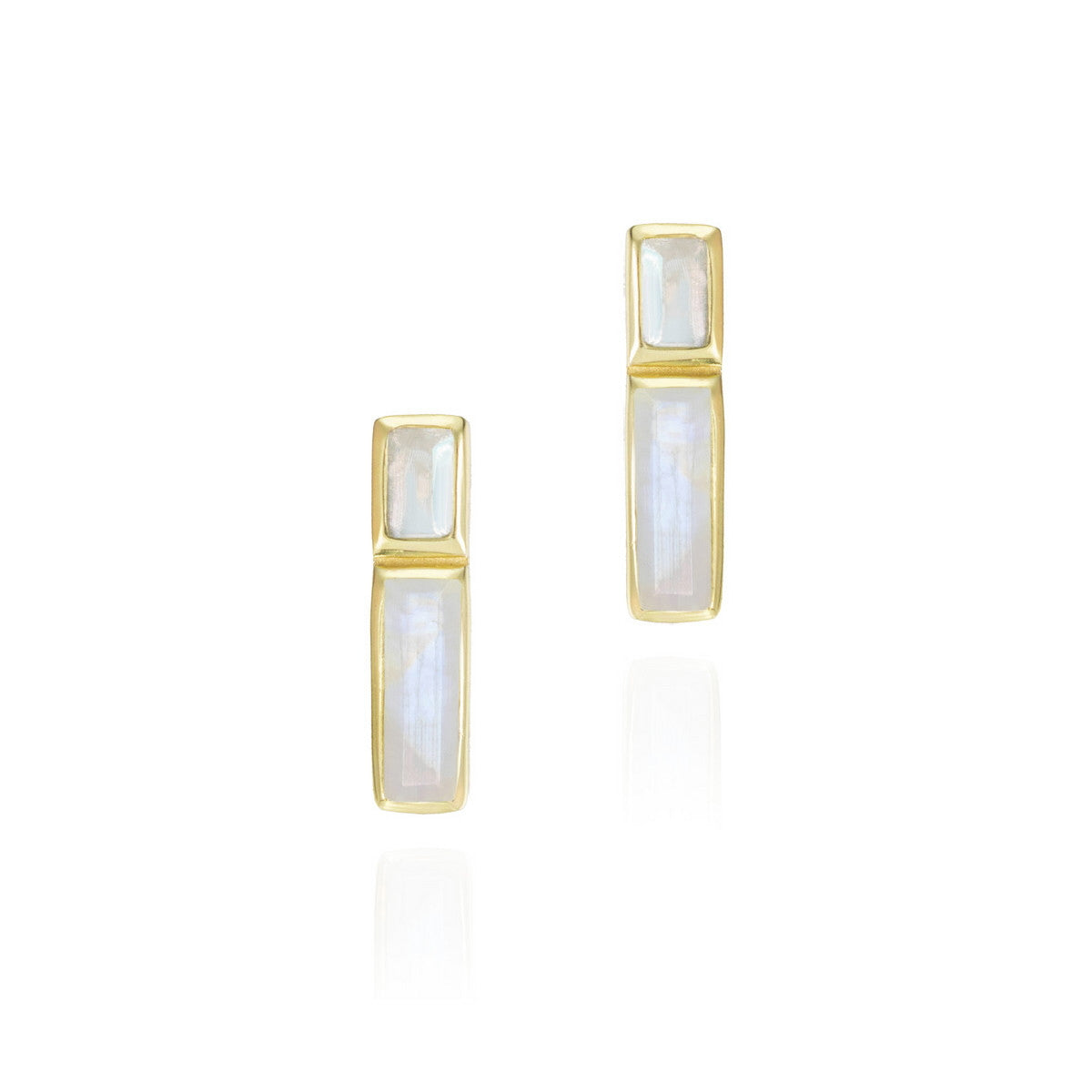 A pair of gold geometric stud earrings featuring rectangular iridescent white stones, displayed on a clean white background with soft reflections below.