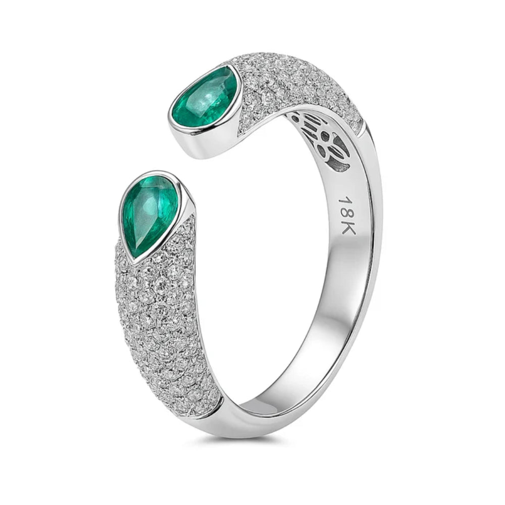 Silver ring with emerald stones on a white background