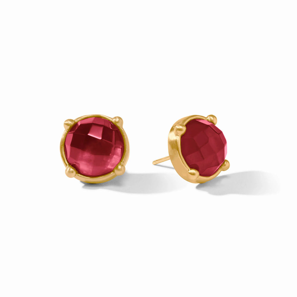 A pair of gold stud earrings with faceted round red gemstones in a prong setting, shown on a clean white background.