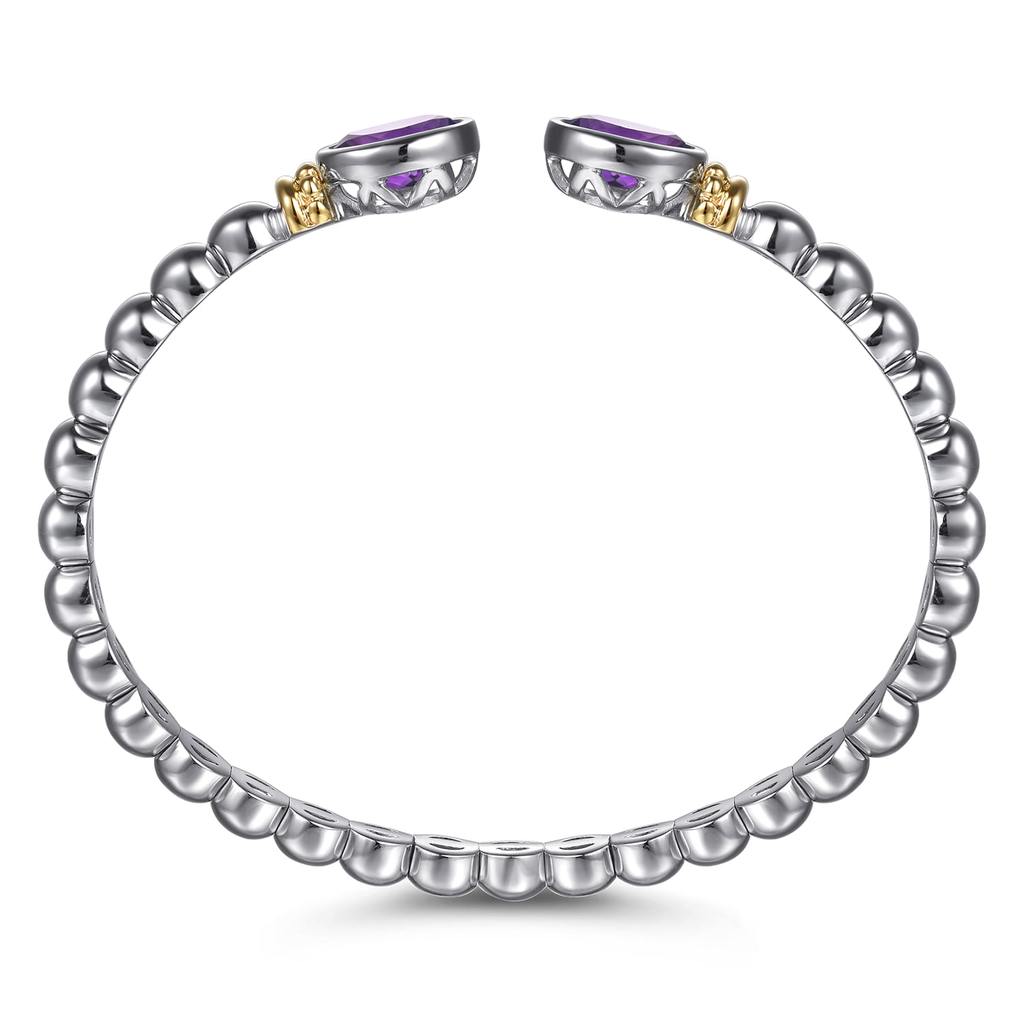 Silver ring with purple gemstones on a white background