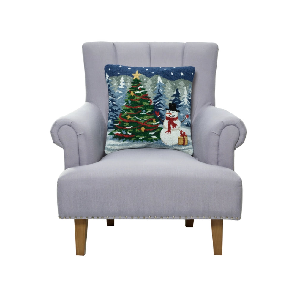 Gray armchair with a Christmas-themed pillow featuring a tree and snowman on a white background