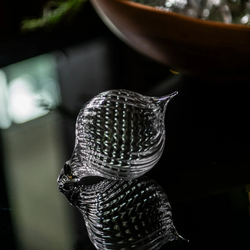 Clear glass hanging ornament on a table