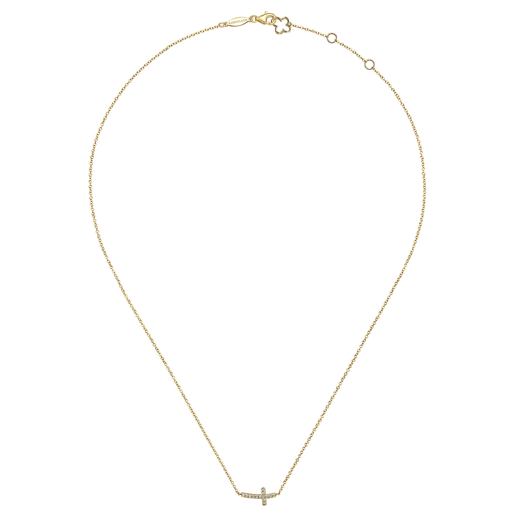 Gold necklace with a small cross pendant on a white background