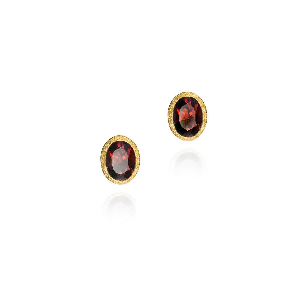 Two red stones with gold frame on white background