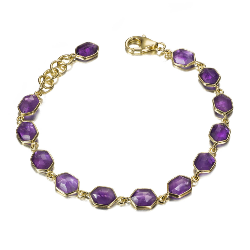 Gold bracelet with purple gemstones on a white background