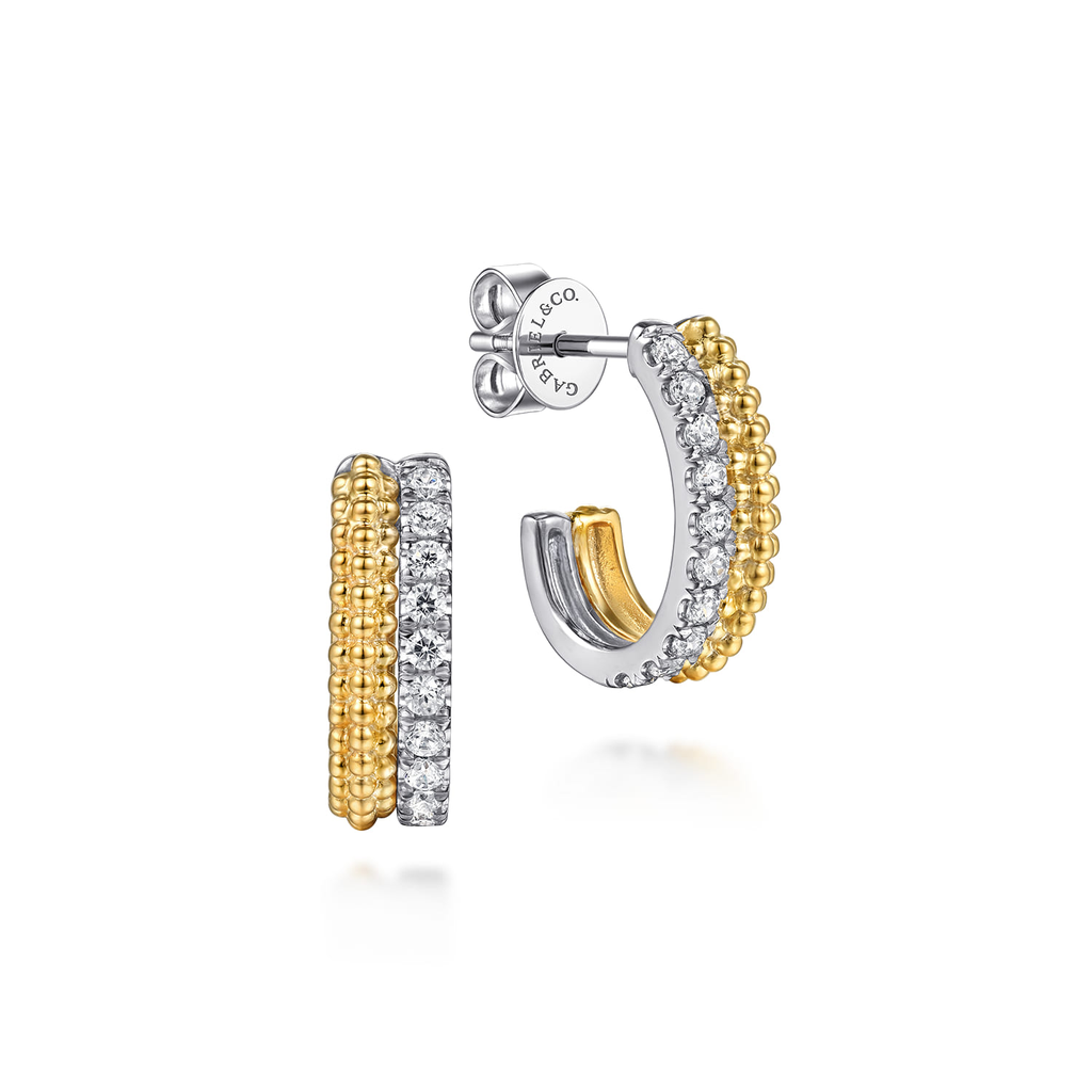 gold and silver hoop earrings with clear stones on white background