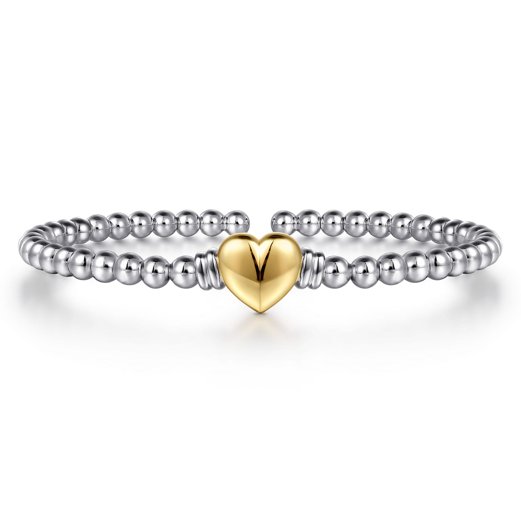 Bracelet with a gold heart charm on a white background
