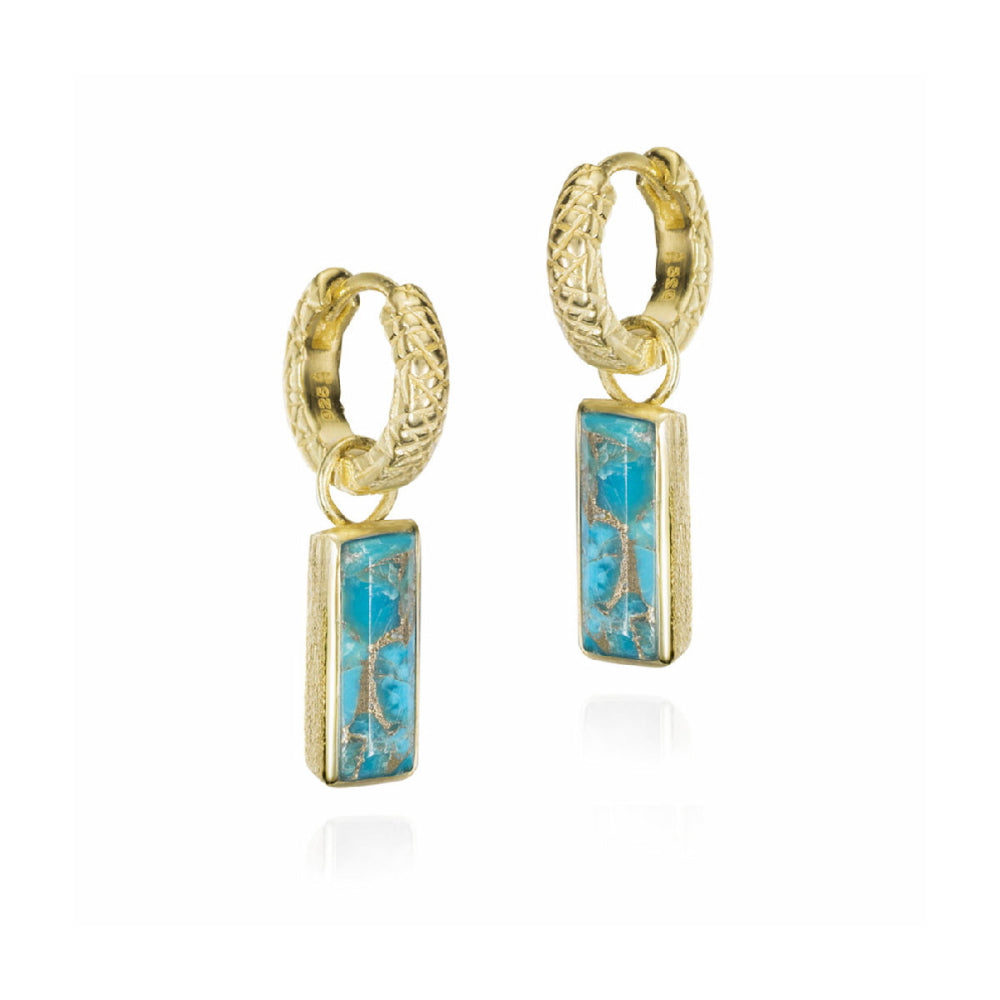 A pair of gold huggie hoop earrings with rectangular turquoise blue stone charms, displayed on a clean white background.