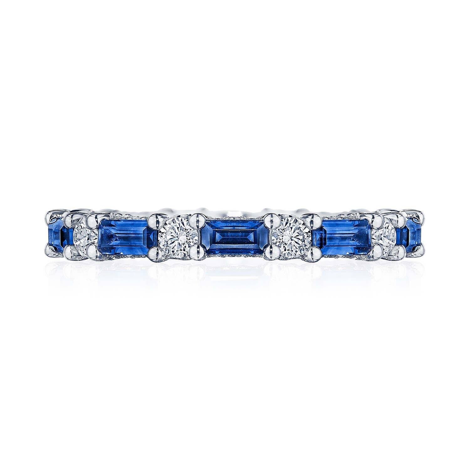 Eternity ring with blue sapphires and diamonds on a white background