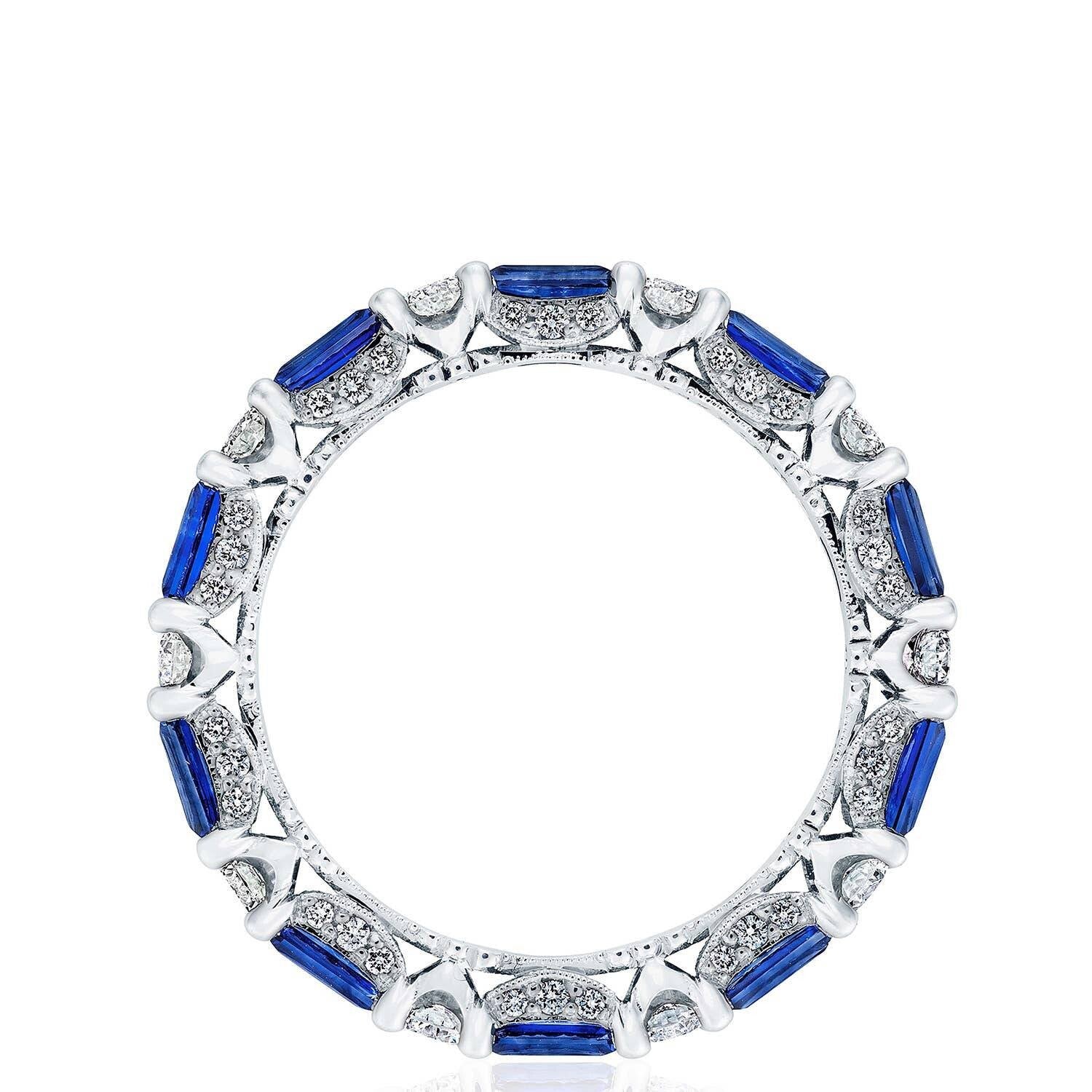 Elegant ring with blue gemstones and white accents on a white background