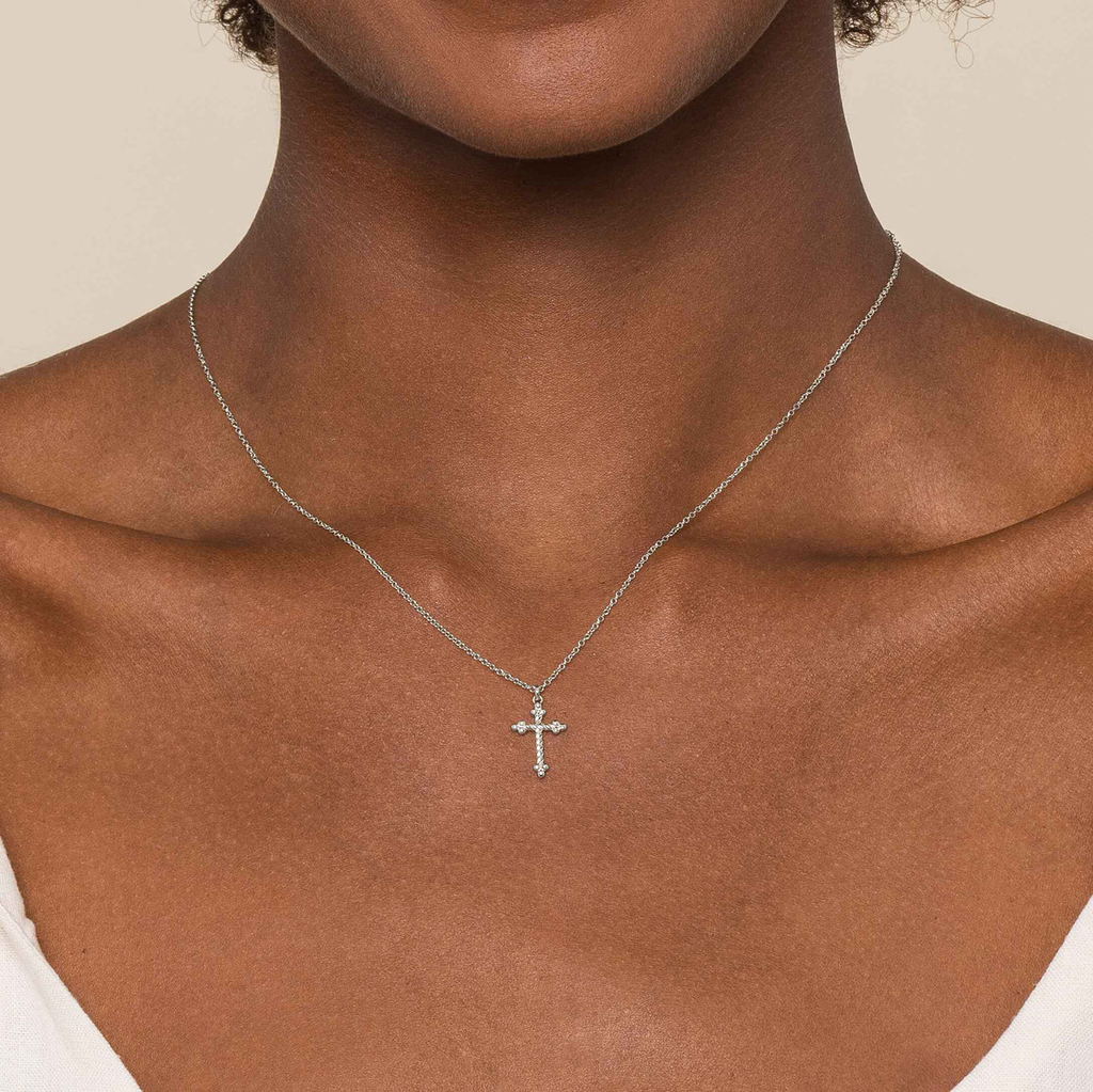 girl wear silver twist cross pendant necklace on natural background