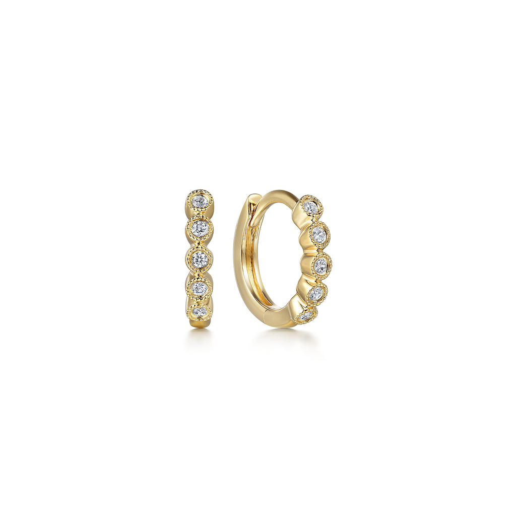 Gold hoop earrings with small diamonds on a white background