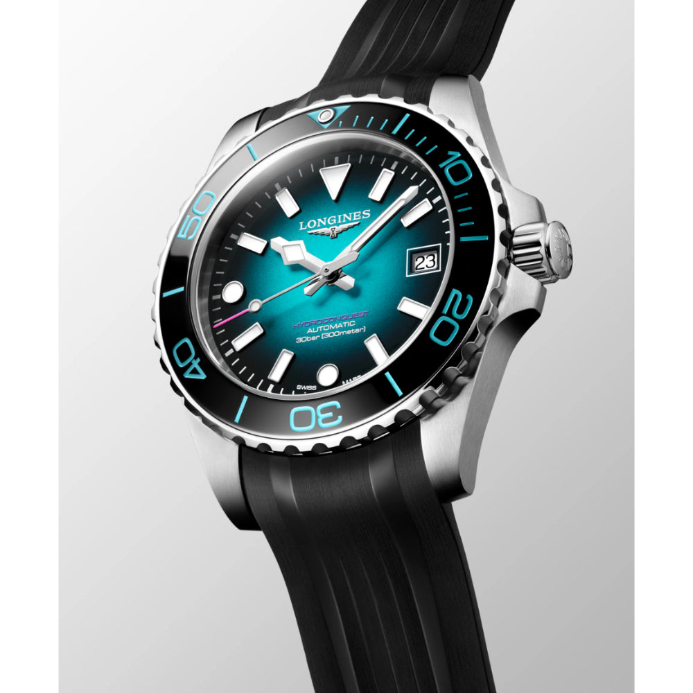 Longines watch with black strap and blue dial on a light gray background