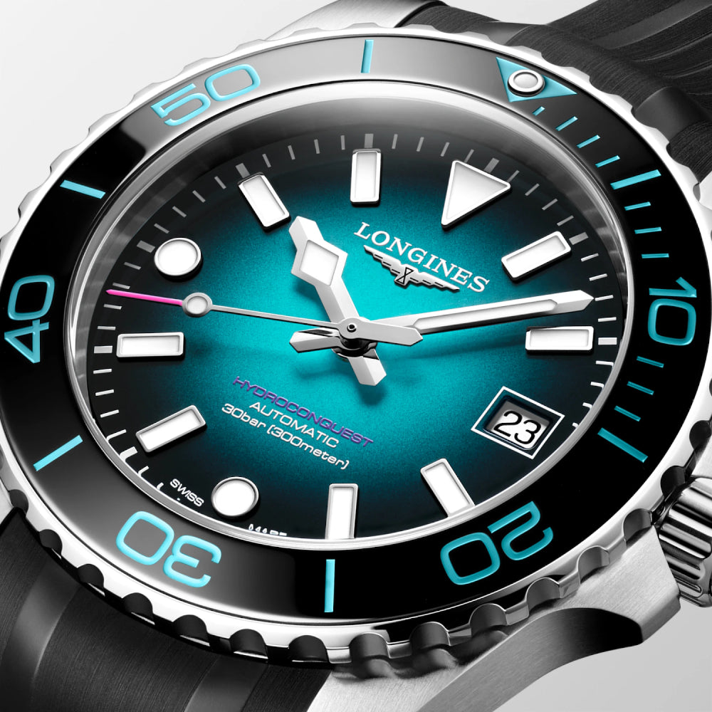 Longines watch with a blue face and black strap on a light gray background