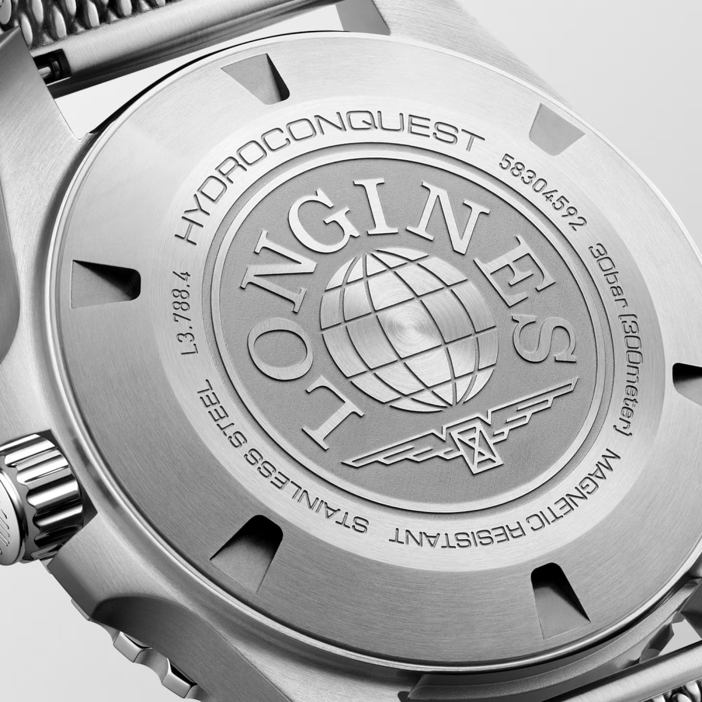 Close-up of a Longines watch caseback with branding and model number.