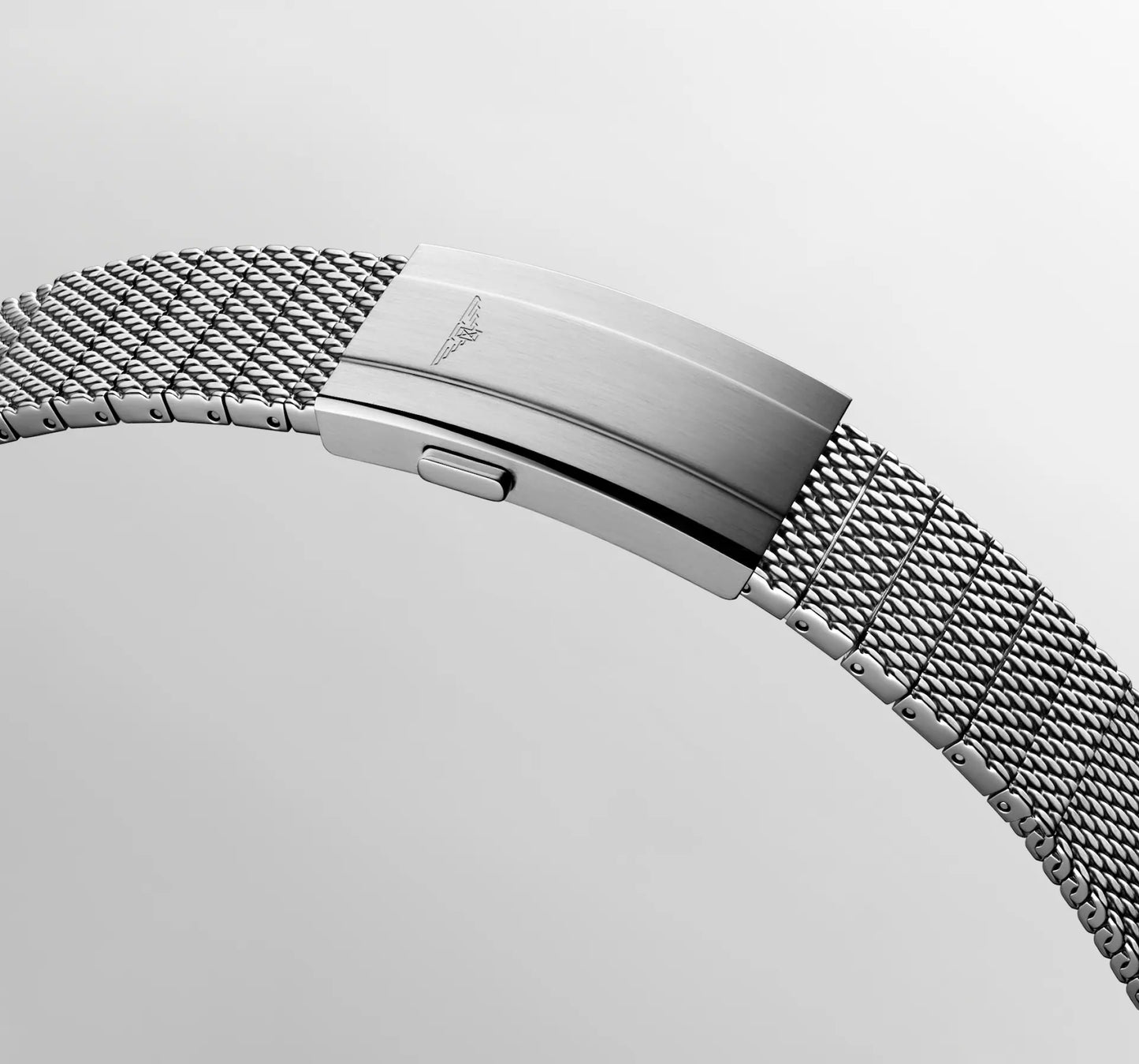 Close-up of a silver watch with a mesh band on a light gray background