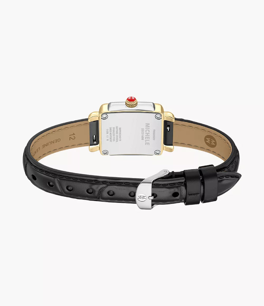 The back view of a MICHELE watch featuring a gold-tone rectangular case with a red crown accent, a silver-tone backplate, and a black leather strap with a silver buckle, set against a light gray background.
