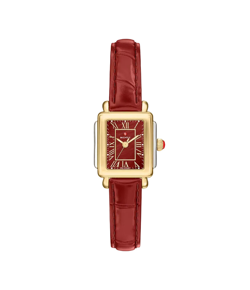 A rectangular gold-tone watch with a deep red dial and a matching red leather strap, shown against a plain white background.