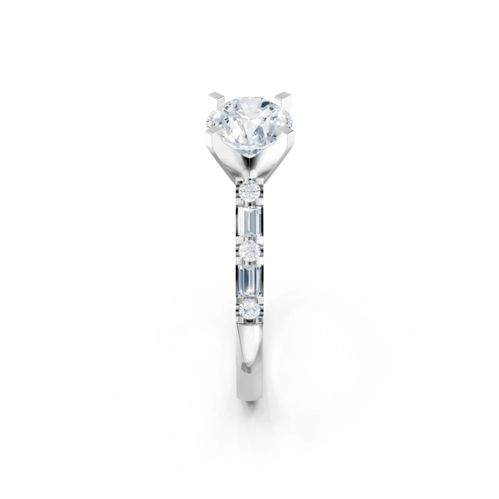 A silver solitaire engagement ring featuring a round brilliant-cut center stone and three baguette-cut side stones, shown on a clean white background.