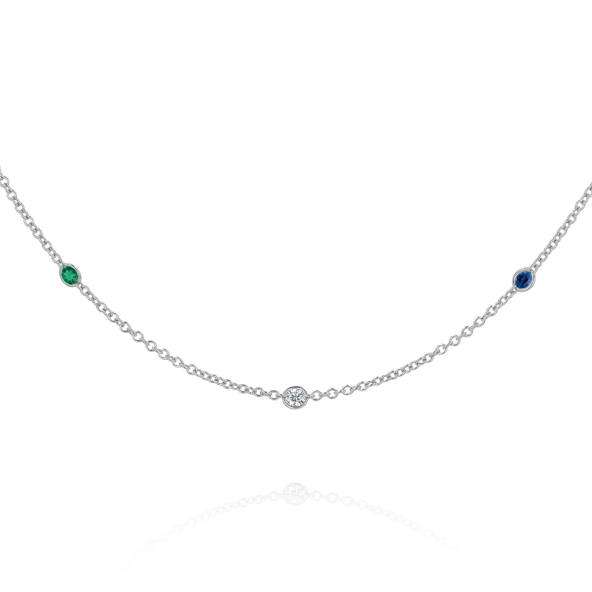 A white gold chain with 3 round gemstone stations on a white background