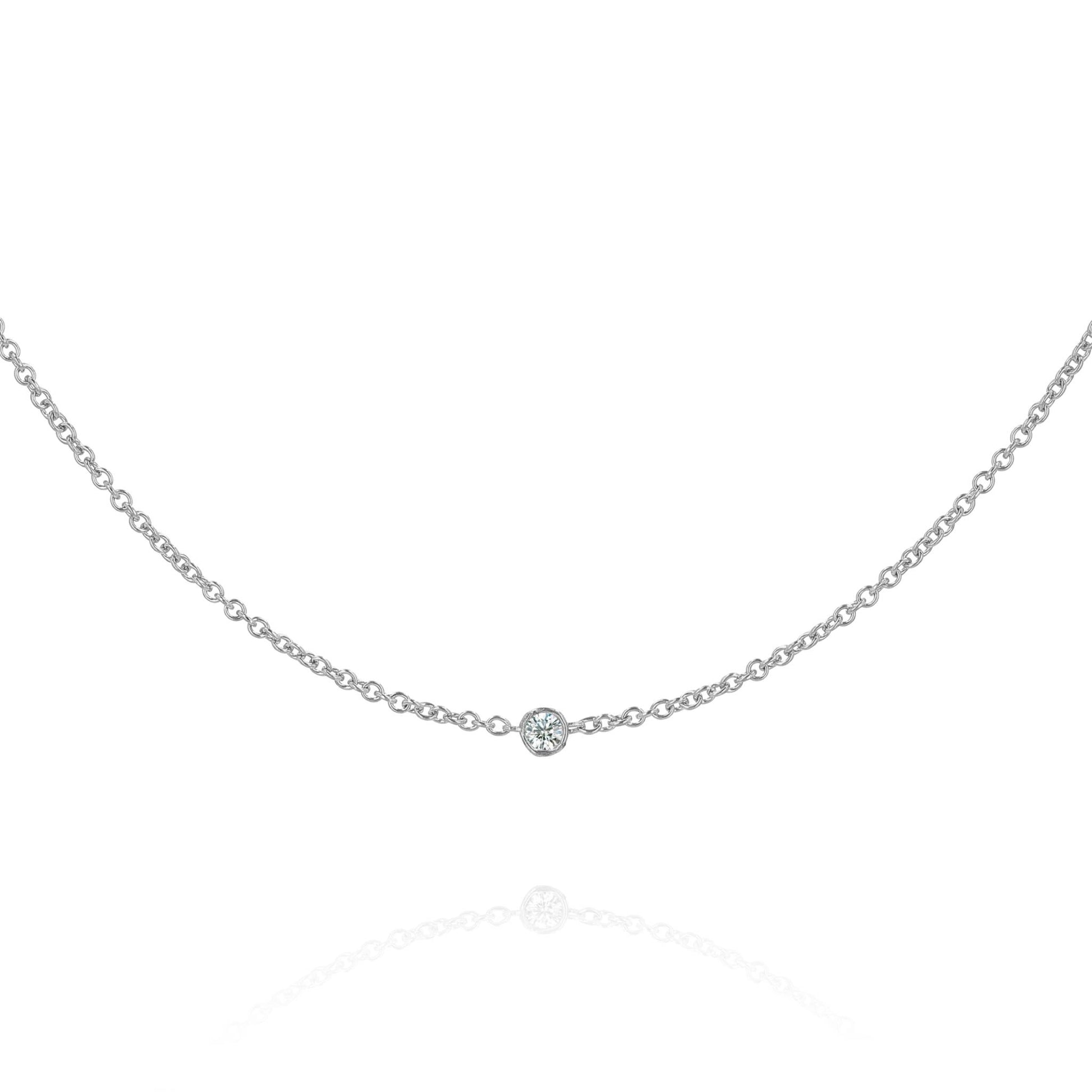 A white gold chain with a single diamond station on a white background
