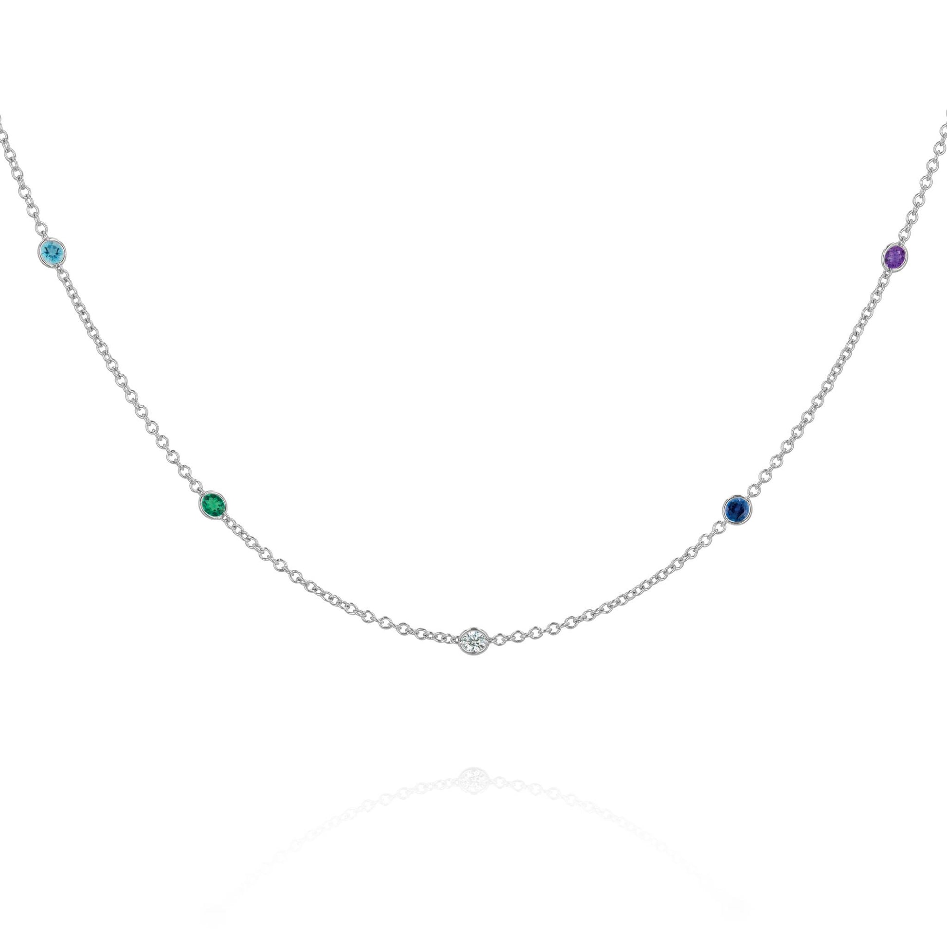 A white gold chain with 5 round gemstone stations on a white background