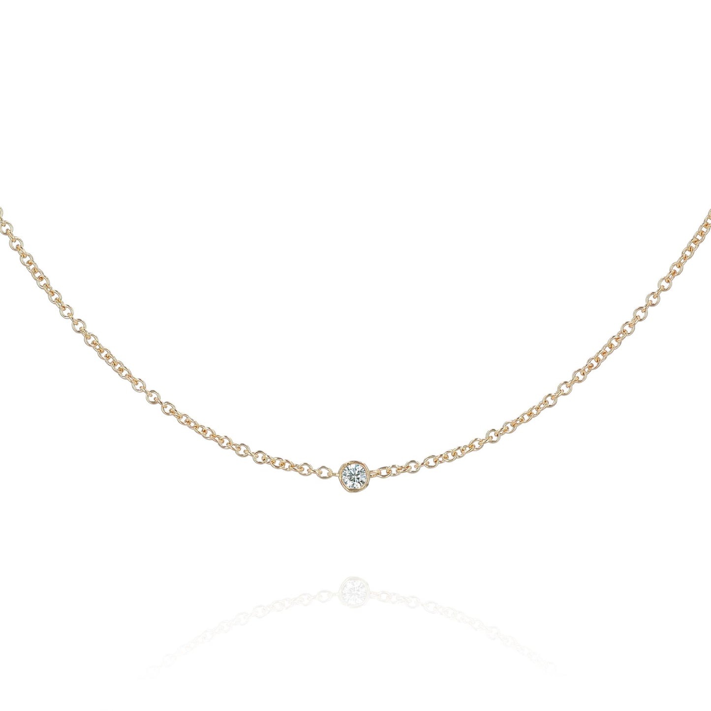 A yellow gold chain with a single diamond station on a white background