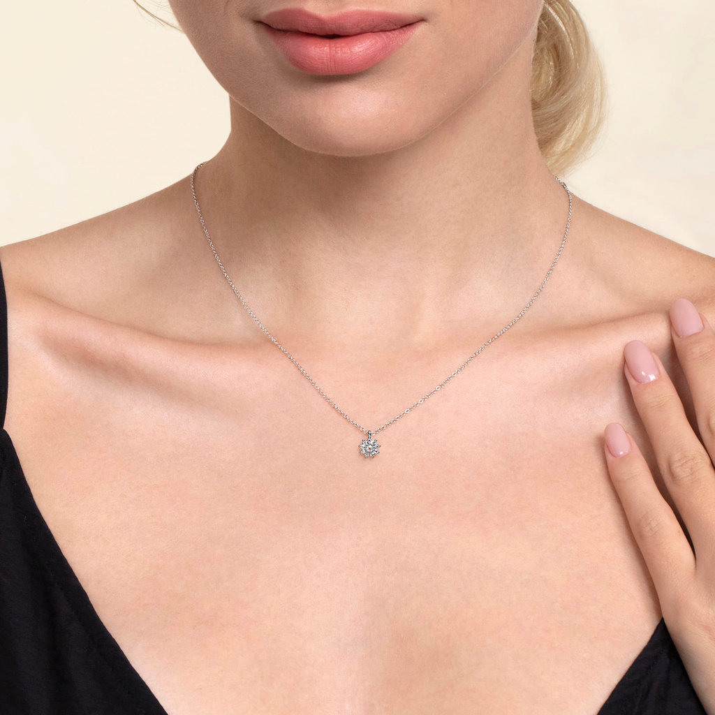 girl wearing white gold pendant necklace on natural background