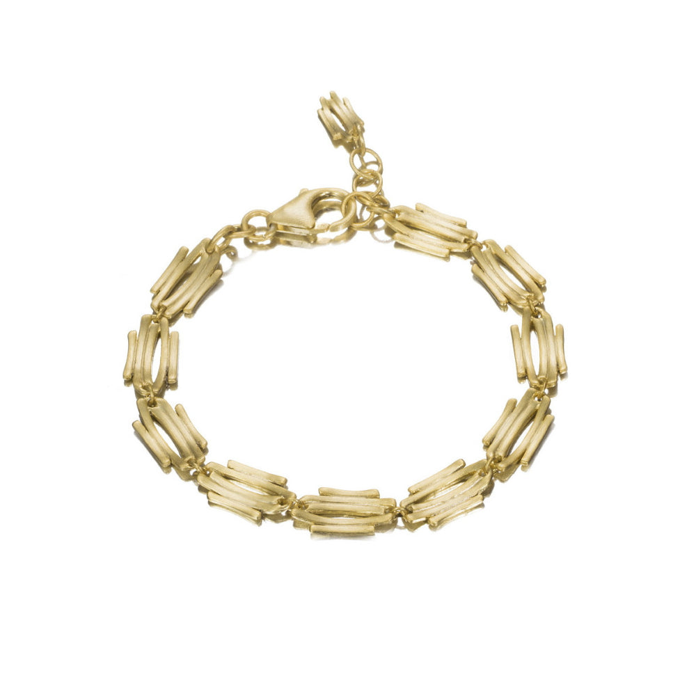 A gold link bracelet made of polished cylindrical tubes arranged in a circular shape, featuring a lobster clasp closure, shown on a plain white background.