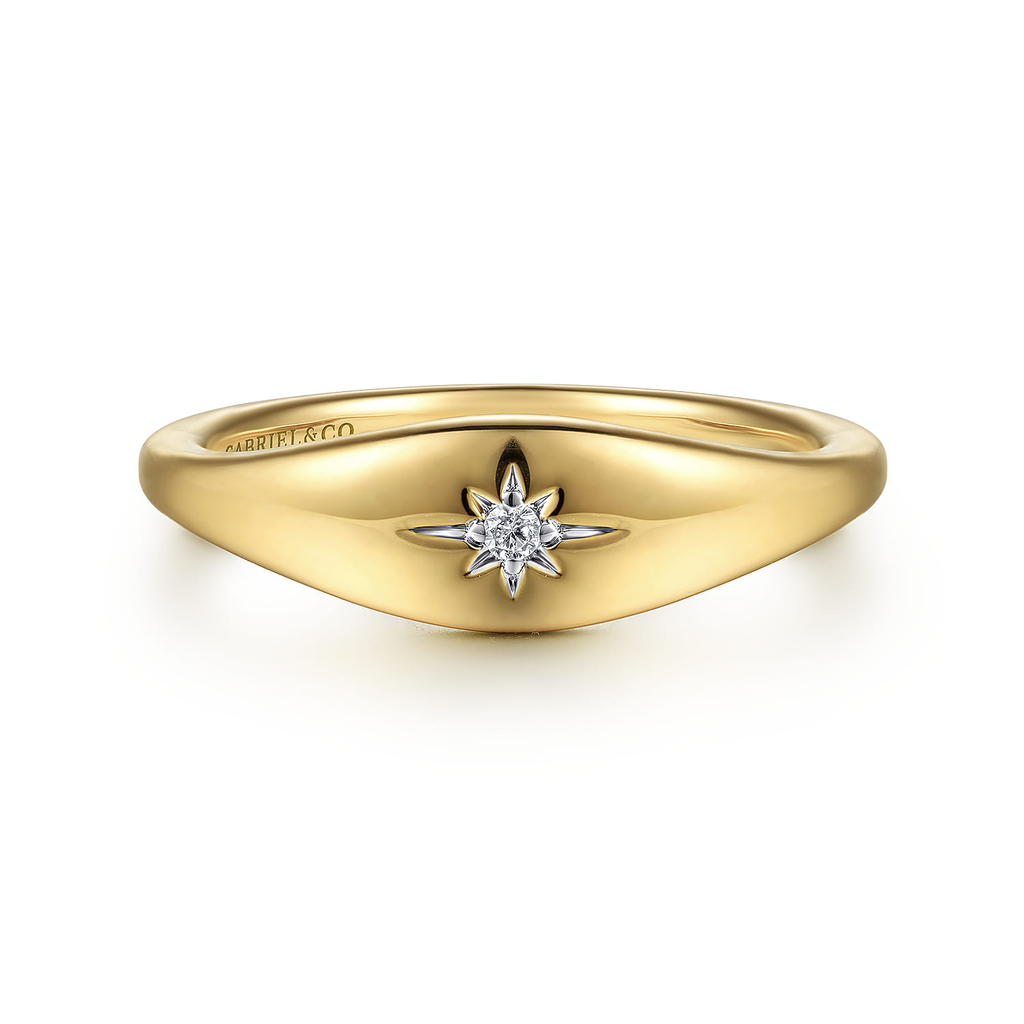 Gold ring with a diamond on a white background