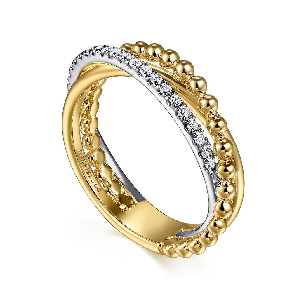 gold and silver ring with clear stones on white background