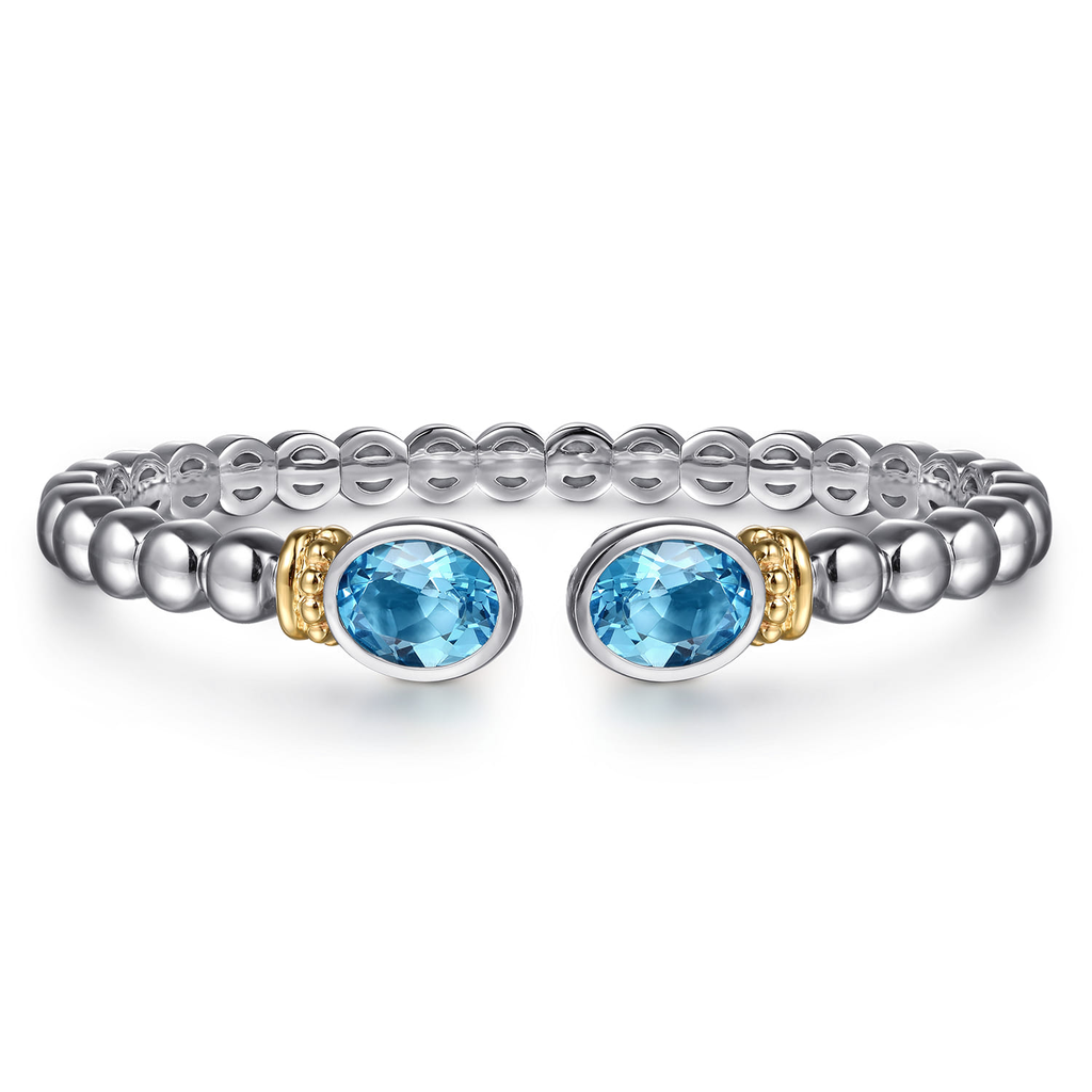 Silver beaded bracelet with blue gemstones on a white background