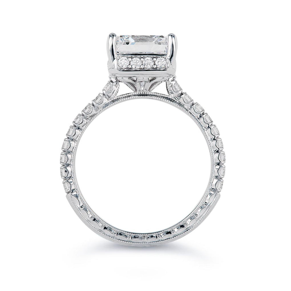 White gold diamond engagement ring with diamond accents and an emerald cut cubic zirconia center on a white background