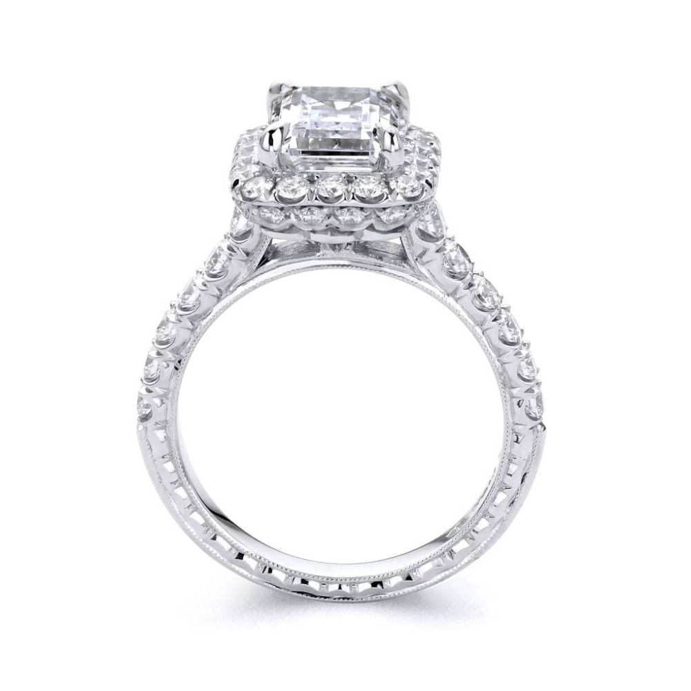 Platinum diamond engagement ring with diamond accents and an emerald cut cubic zirconia center on a white background