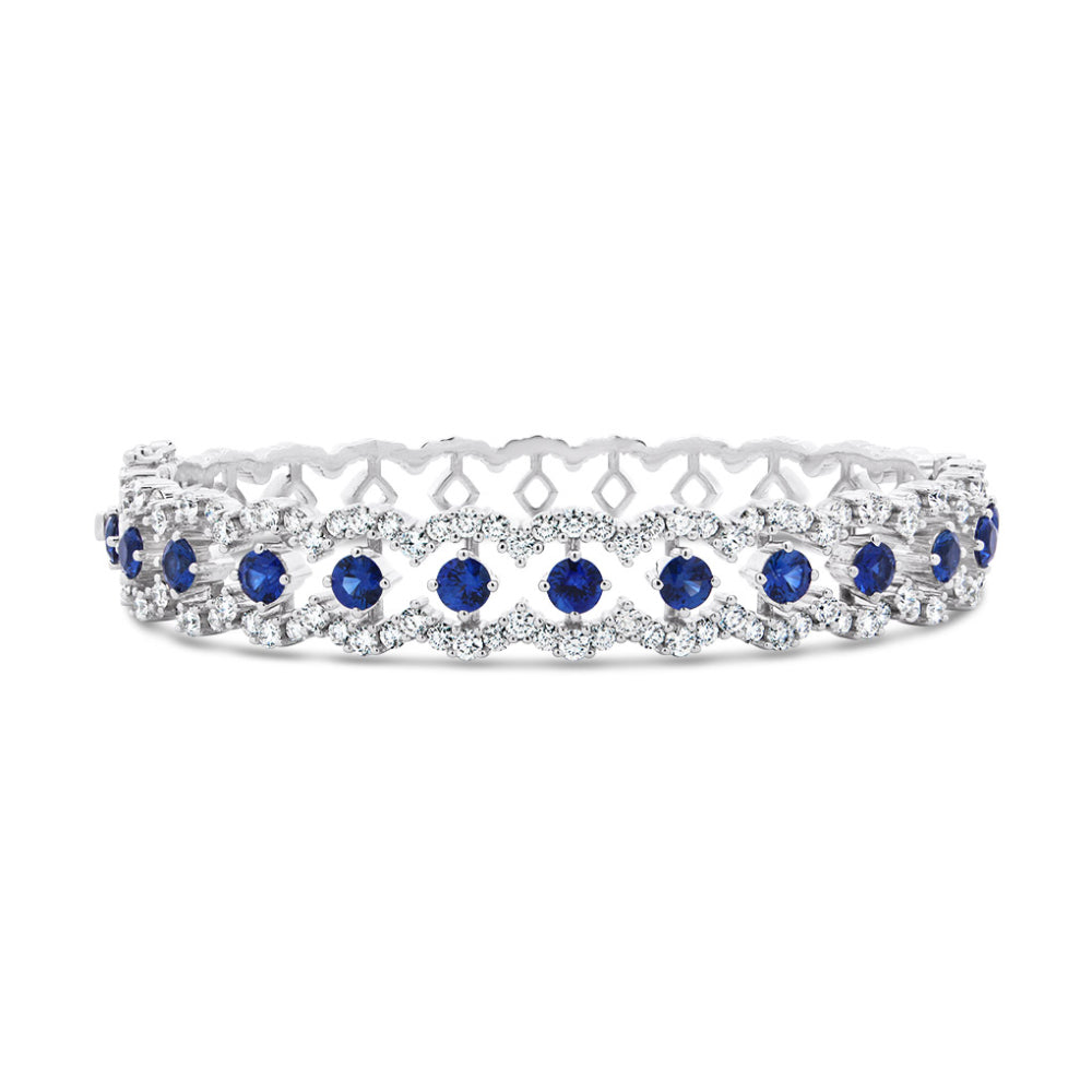 White gold bracelet with diamond and blue sapphire accents on a white background
