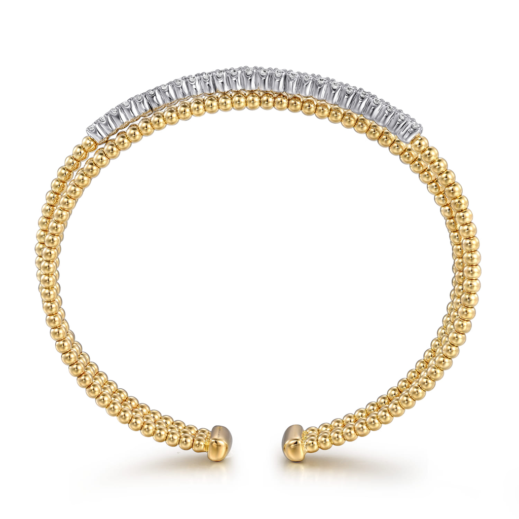 gold and silver wrap beaded bracelet with clear stones on white background from side