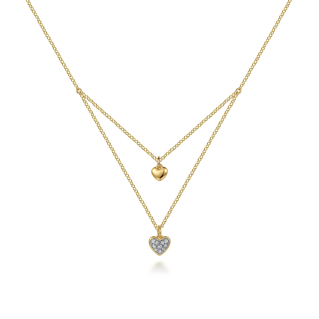 Two gold necklaces with heart pendants on a white background
