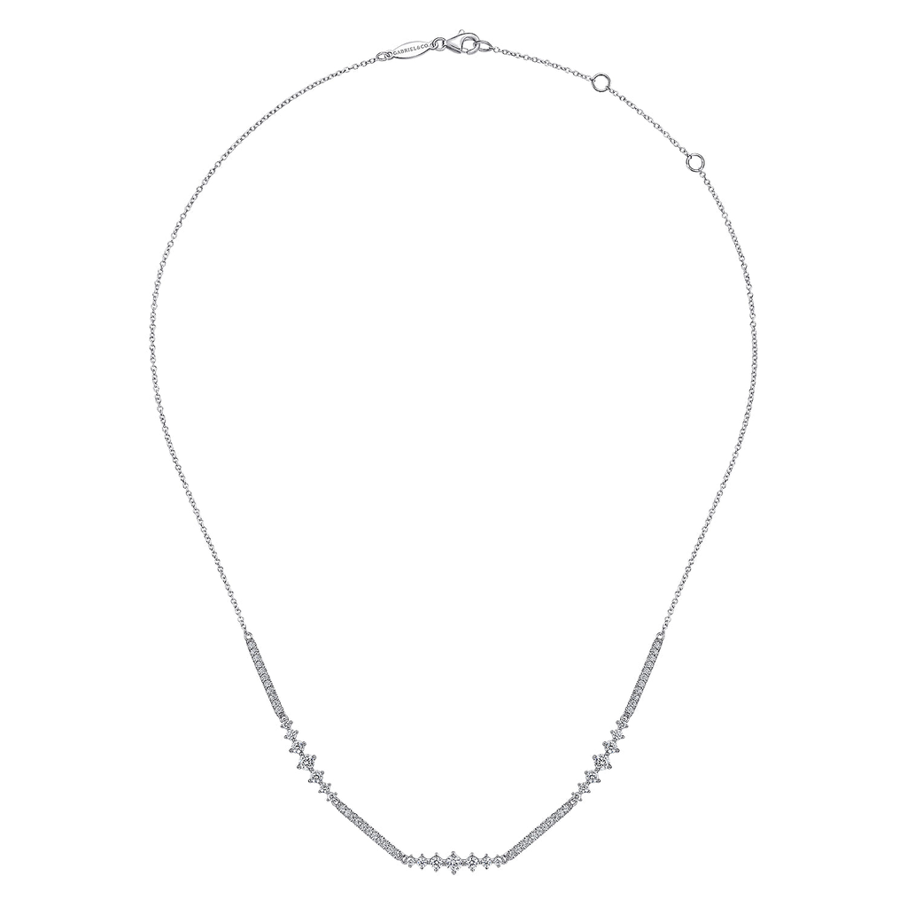 silver necklace with clear stones on white background