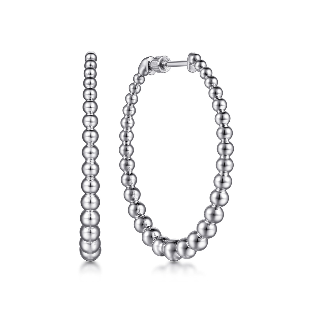 Silver hoop earrings with beaded design on a white background