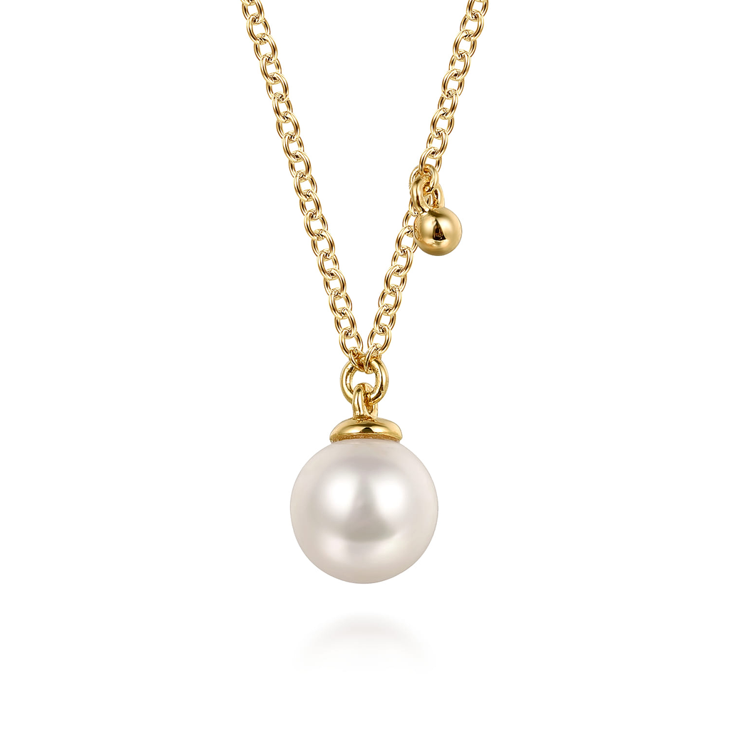 yellow gold necklace with pearl on white background