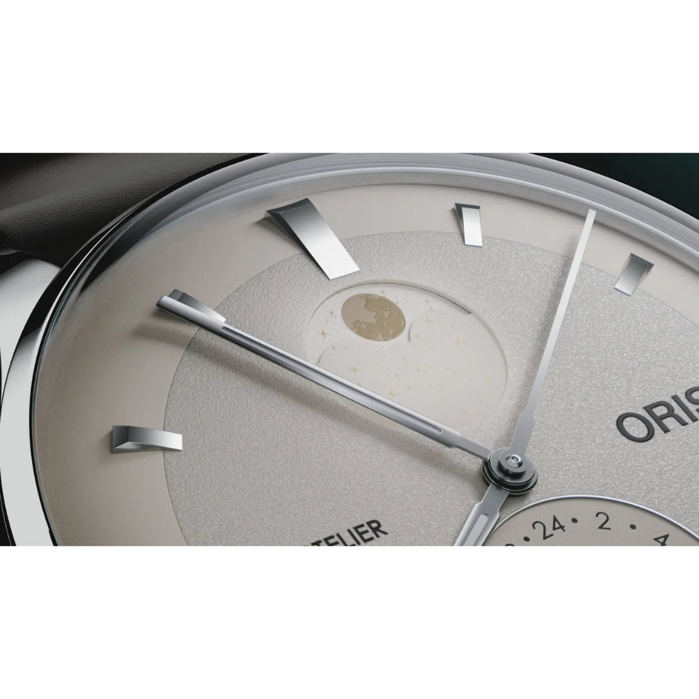 Close-up of an Oris watch dial with a textured light beige/gray face, silver-tone hands and hour markers, and part of a 24-hour subdial.
