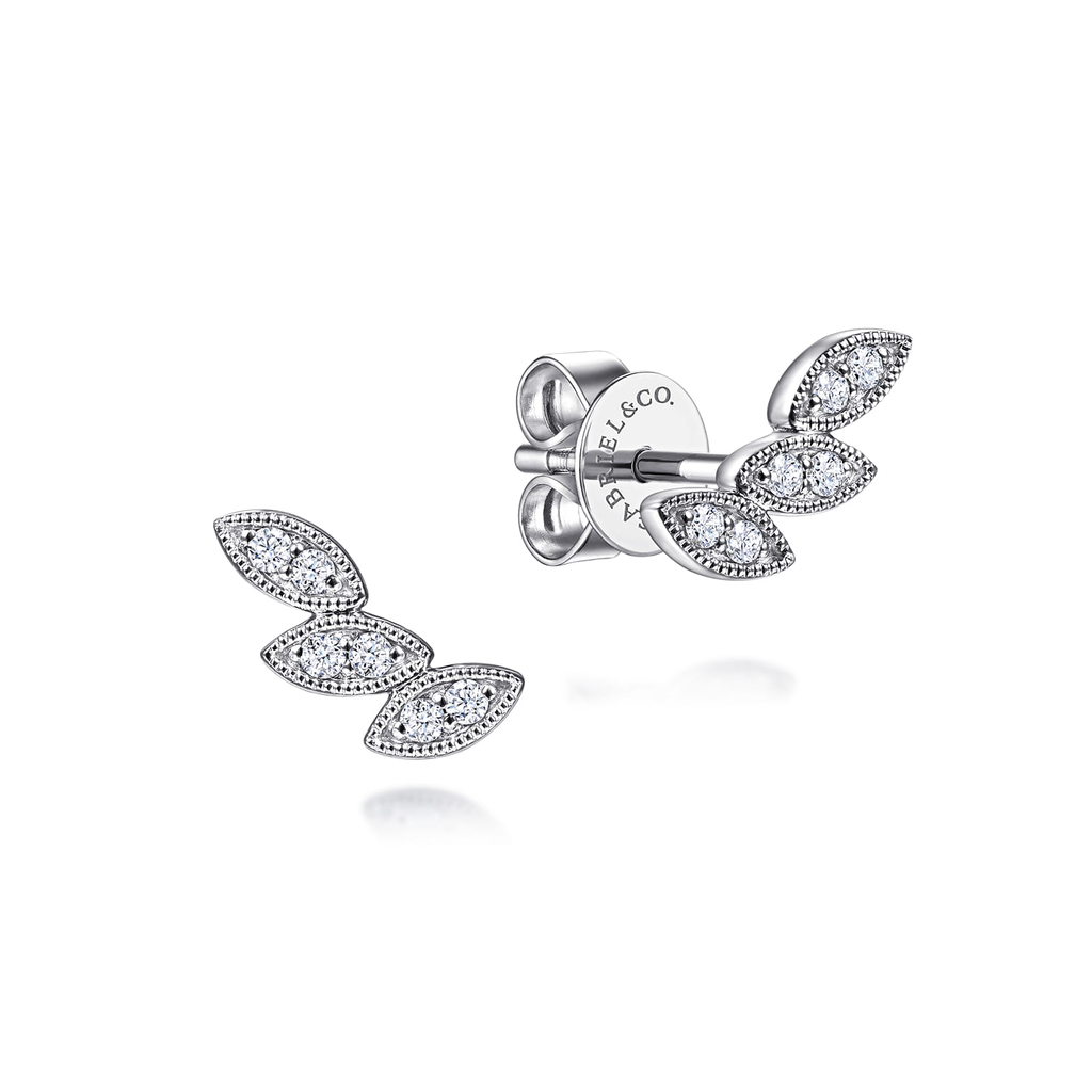 Silver leaf-shaped earrings with clear gemstones on a white background