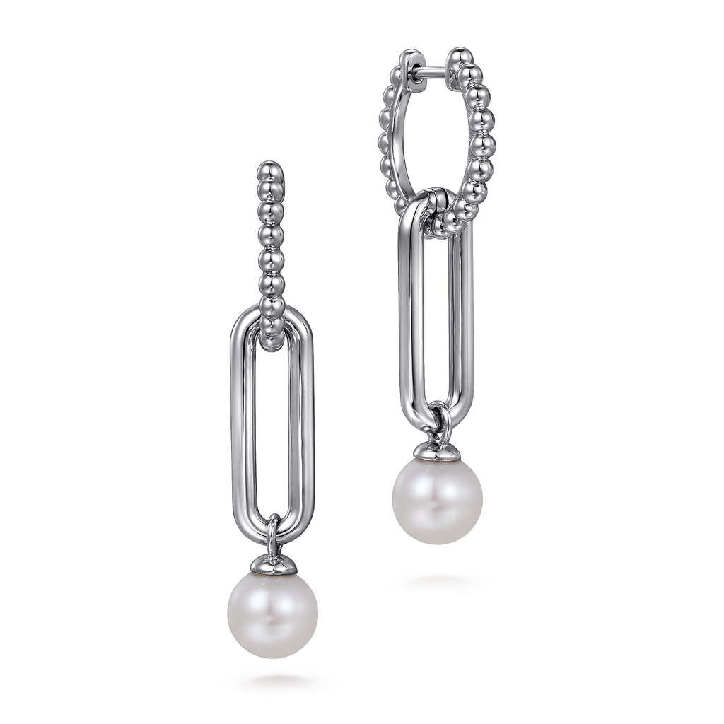 Pair of silver hoop earrings with pearl drops on a white background