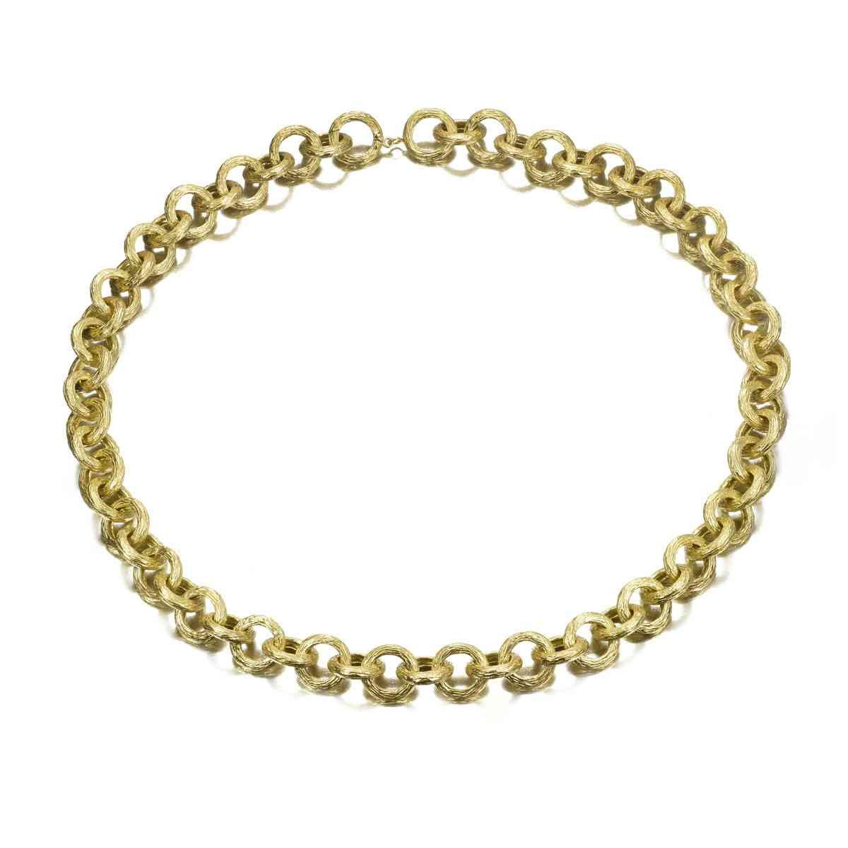 A gold chain necklace with a classic curb link design, arranged in a circle on a plain white background.