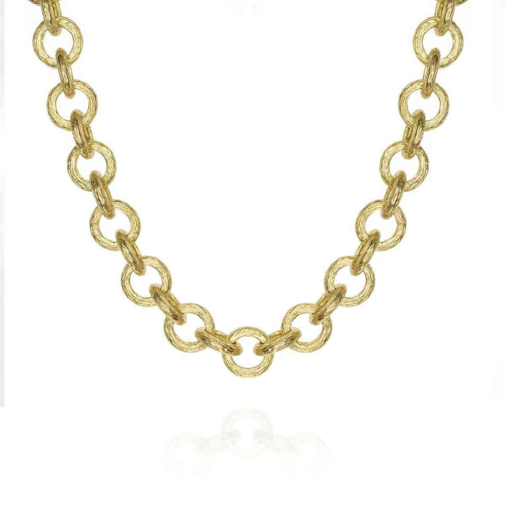 A gold chain necklace with textured oval links, displayed on a clean white background with a subtle reflection below.