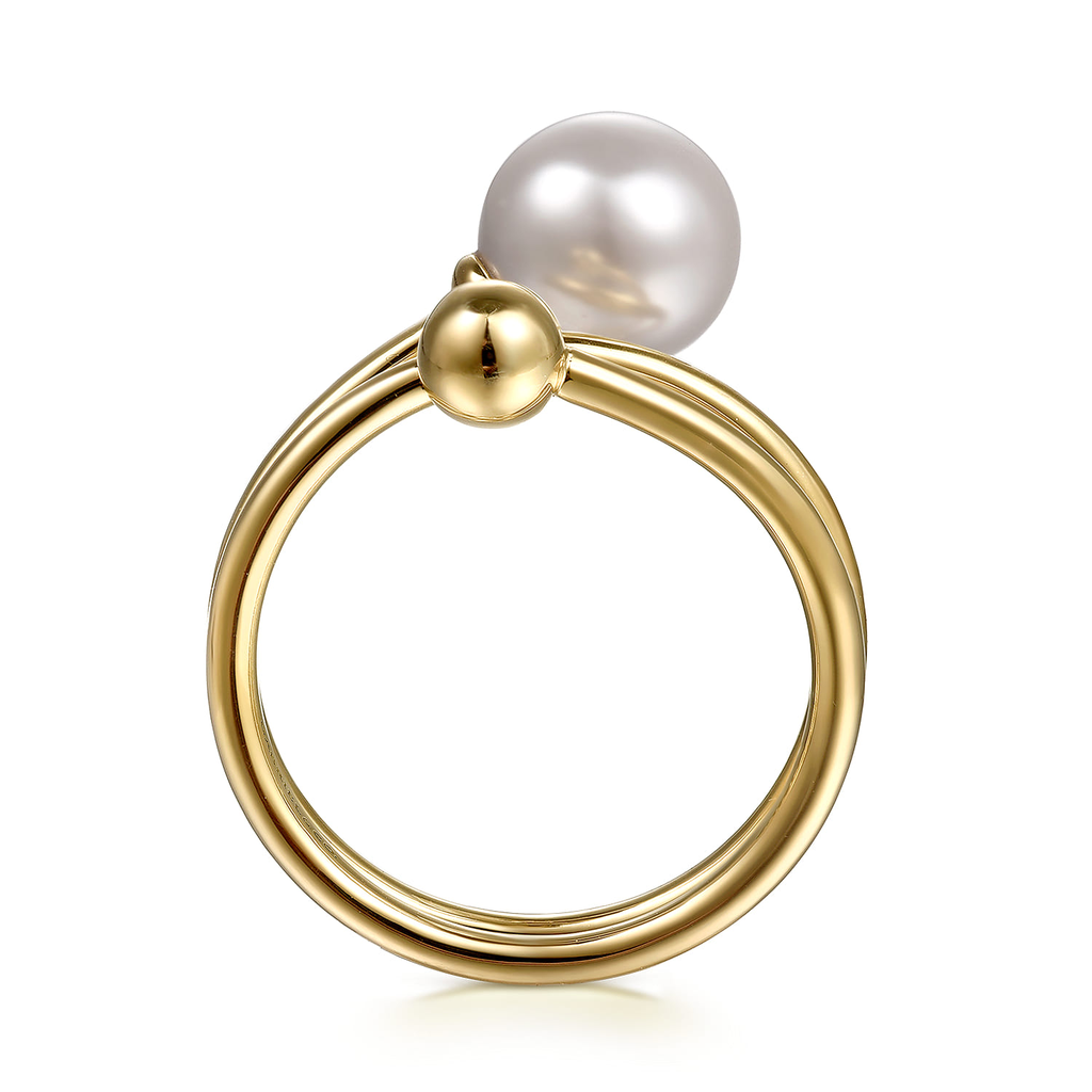 Gold ring with a pearl on a white background