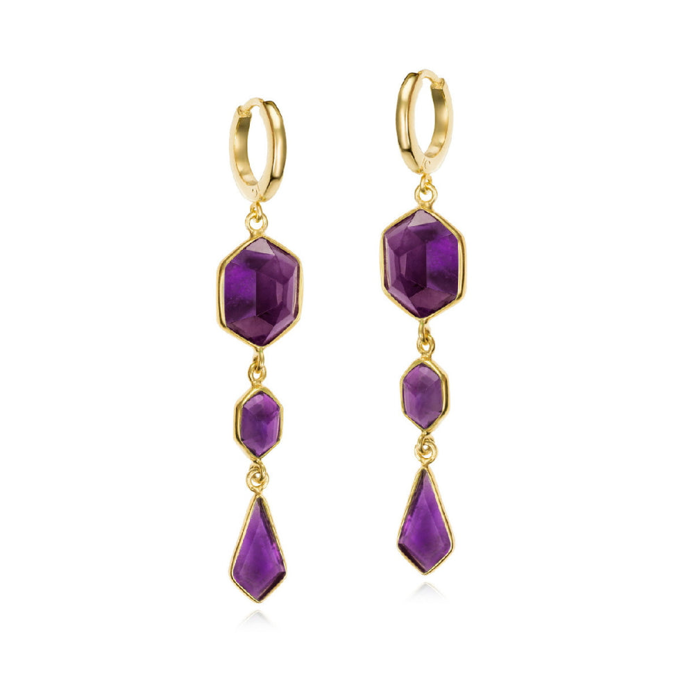 A pair of gold hoop drop earrings featuring faceted purple gemstones in a geometric dangle design, shown against a plain white background.