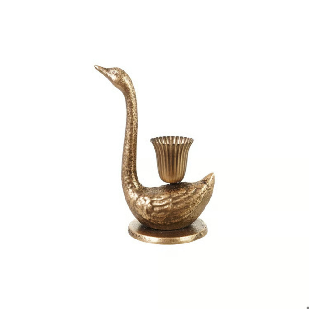 A decorative swan-shaped candle holder in a textured metallic gold finish, featuring a fluted cup on its back and a round base, set against a plain white background.