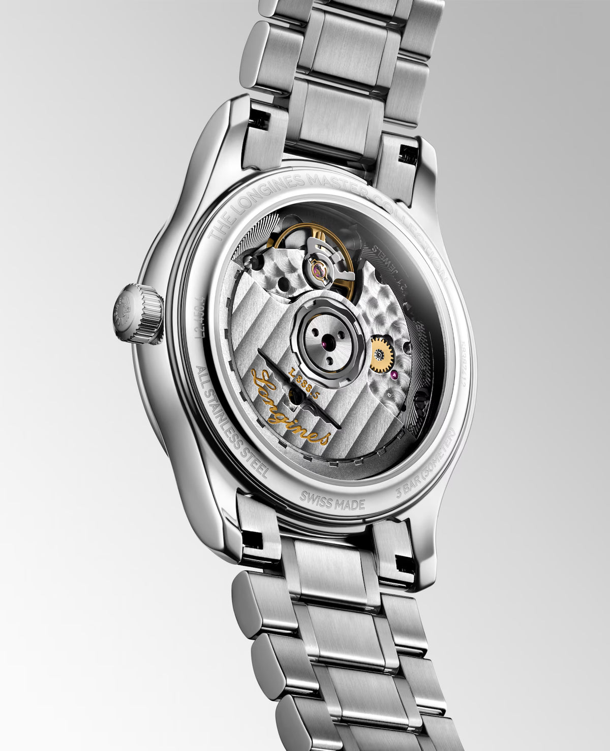 Silver watch with open face revealing mechanical components on a light gray background