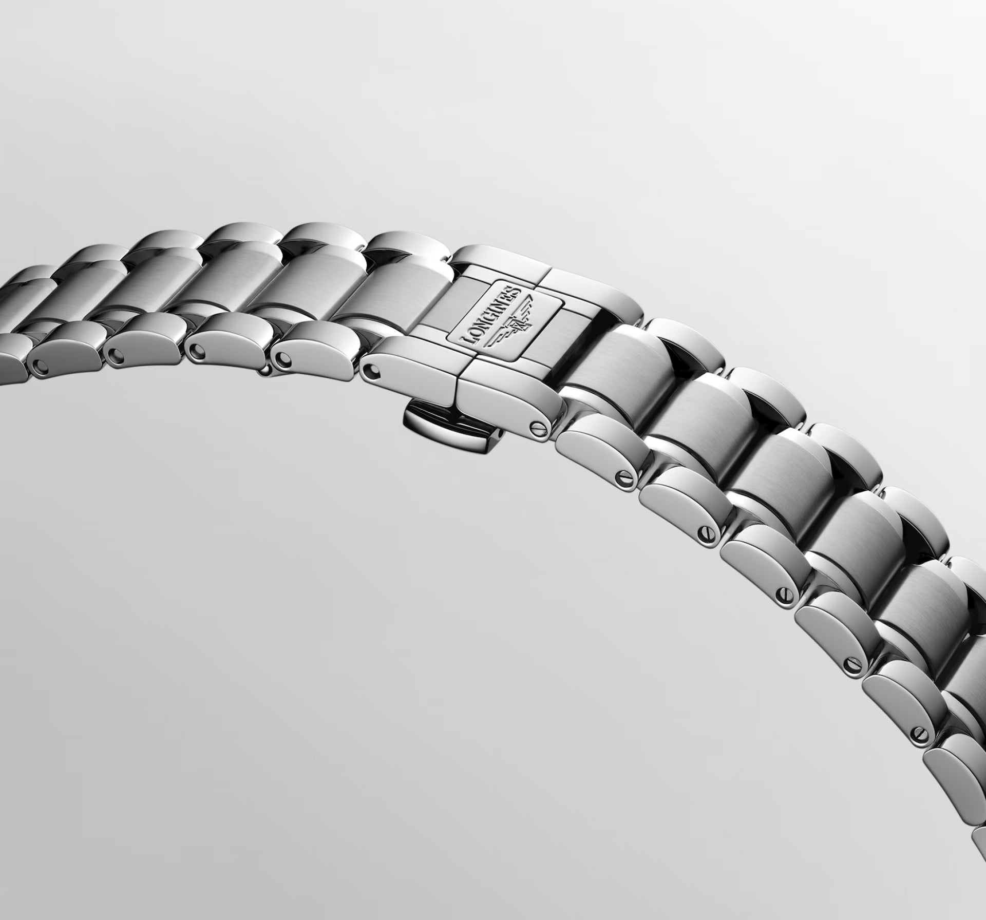 Close-up of a stainless steel link watch band clasp, showing the Laurence-Marinelli brand name and logo engraved on the clasp, set against a clean light gray background.
